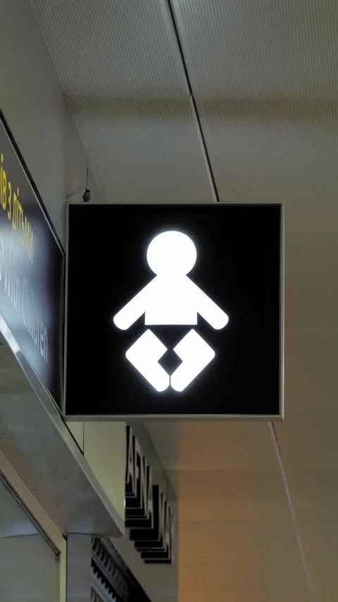 Pointer. room for passengers with children. signpost at the airport. baby in a Stock Footage 305940018