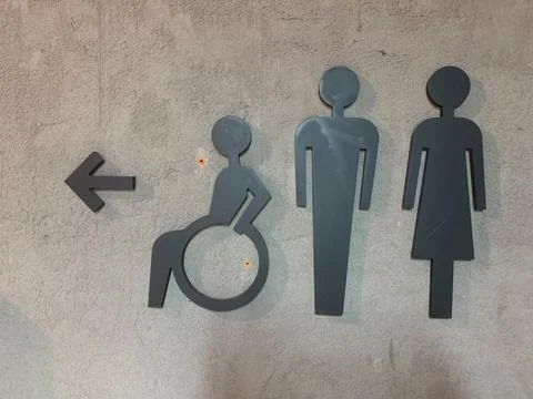 Pointer to the toilet inside the room. Stock Photos