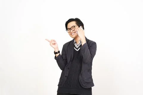 Pointing aside with forefinger while on phone Of Handsome Asian Man Isolate.. Stock Photos