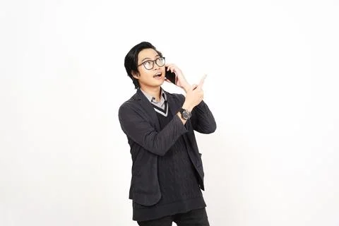 Pointing aside with forefinger while on phone Of Handsome Asian Man Isolate.. Stock Photos