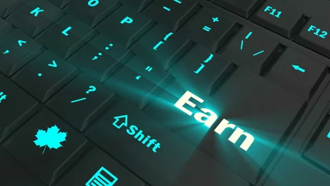 Pointing on blue glowing Earn key Stock Footage 100607787