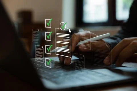 Pointing to check mark electronic document, Paperless quality assurance. Stock Photos