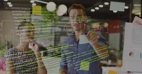 Pointing coder and trainee holding marker reviewing code on glassboard at work, Stock Photos
