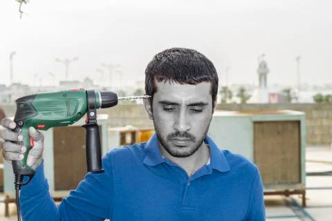 Pointing drill machine and trying to suicide by a drill Stock Photos