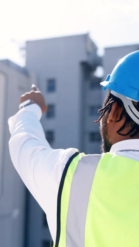 Pointing, engineer and back with black man in city for construction site, view Stock Footage 333308377