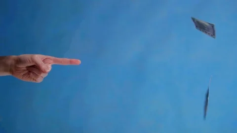 Pointing finger on a blue background and falling banknotes Stock Footage 124660142
