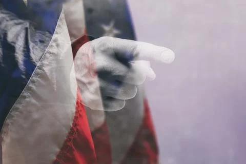 Pointing finger hand gesture the backdrop of the American flag. Concept with  Stock Photos