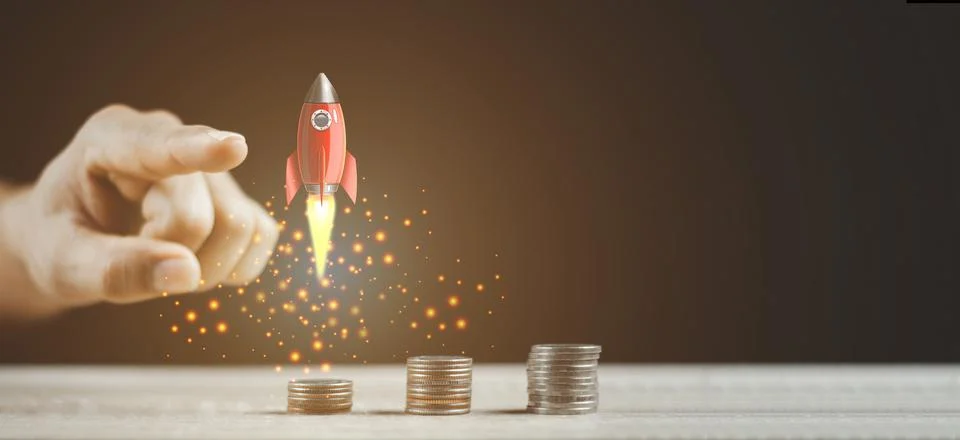 Pointing Flying Rocket Over Increasing Graph Of Coins Stock Photos