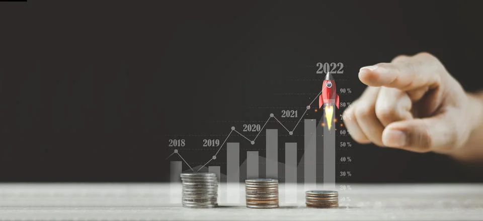 Pointing Flying Rocket Over Increasing Graph Of Coins Stock Photos