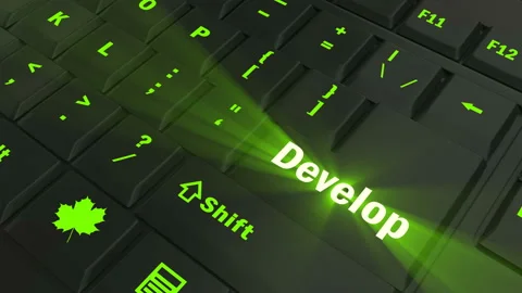 Pointing on green glowing Develop key Stock Footage 100635241