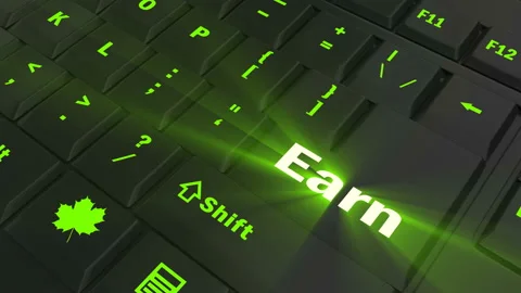 Pointing on green glowing Earn key Video stock 100607813