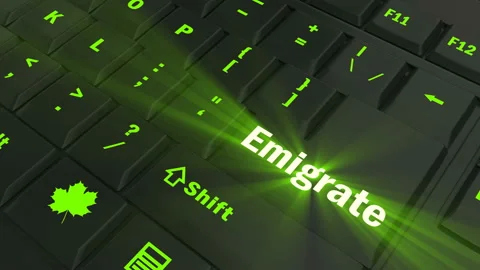 Pointing on green glowing Emigrate key Stock Footage 100635612
