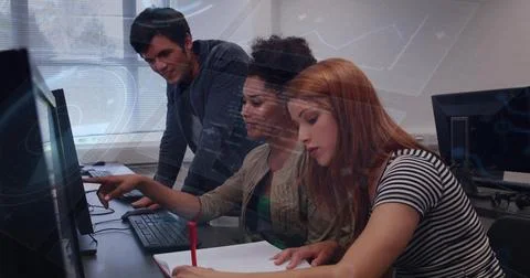 Pointing group of three students collaborating at computer lab, writing with red Stock Photos