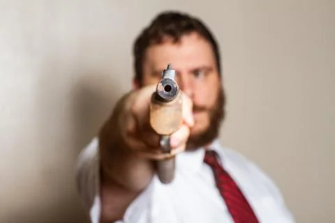 Pointing a gun at the camera Foto stock