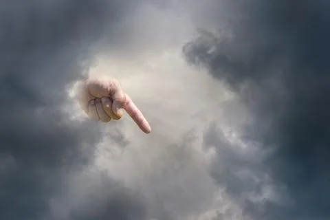 Pointing hand of god with dark clouds 스톡 사진