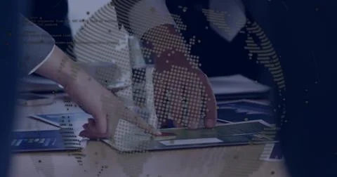 Pointing hands analyzing printed charts at office desk, with digital globe, c 写真素材