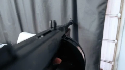 Pointing a machine gun outside paranoid criminal Video stock 123209017
