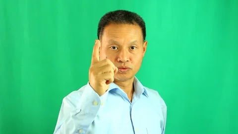 Pointing  man with green  background, in studio Chiangmai Thailand Stock Footage 113310087