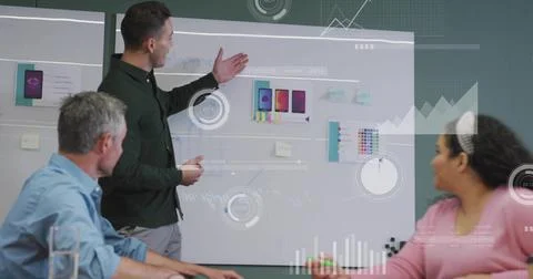 Pointing man presenting app mockups and sticky notes on whiteboard in confere Stock Photos