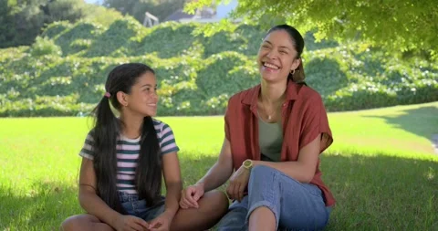 Pointing mother in rust top speaking, guiding daughter on lawn, hugging bonding Vídeo Stock 337294646