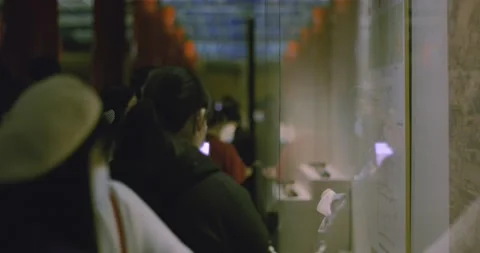 Pointing at Object through Museum glass, Mask, Cap, Looking Stockbeeldmateriaal 143440989