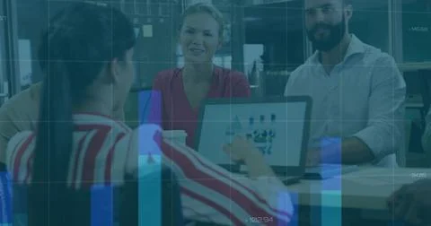 Pointing presenter in red-striped top gesturing toward laptop icons at meeting Stock Photos