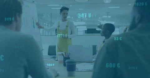 Pointing presenter in yellow overalls explaining flip chart diagrams in meeting Stock Photos