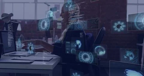 Pointing professional woman highlighting code on laptop in open-plan office, 库存照片