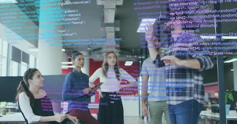 Pointing software developer in plaid shirt explaining code on glass display at 스톡 사진