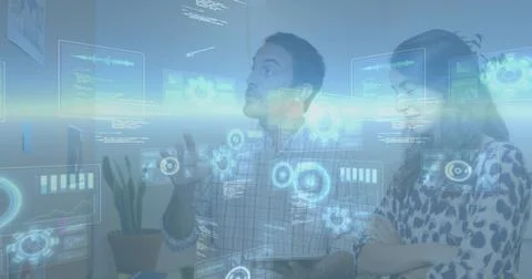 Pointing team reviewing AR UI at office with tablet monitors plant checked shirt Stock Photos