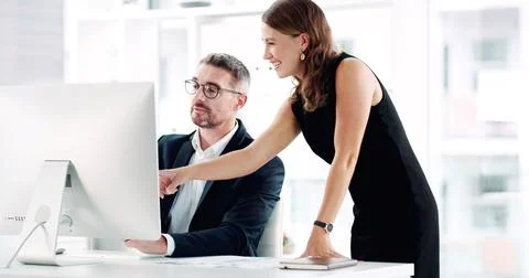 Pointing, teamwork and computer with business people in office for help Stock Photos