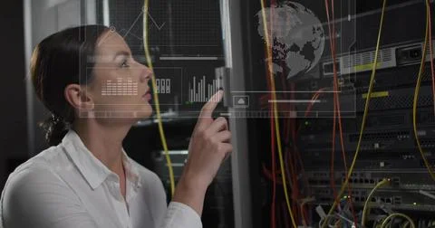 Pointing tech in white shirt using hologram UI at server aisle, yellow orange Stock Photos