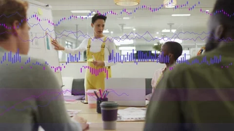 Pointing woman in yellow overalls explaining metrics at flip chart in meeting Stock Footage 332901965