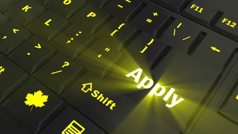 Pointing on yellow glowing Apply key Stock Footage 100607347