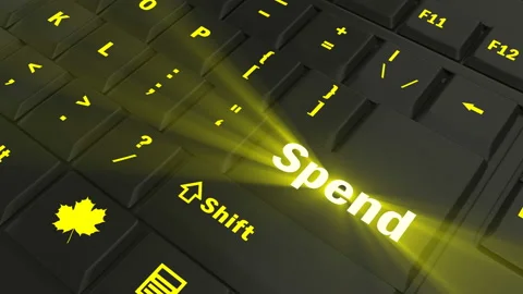 Pointing on yellow glowing Spend key Stock Footage 100583153