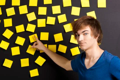 Pointing to a yellow note Stock Photos
