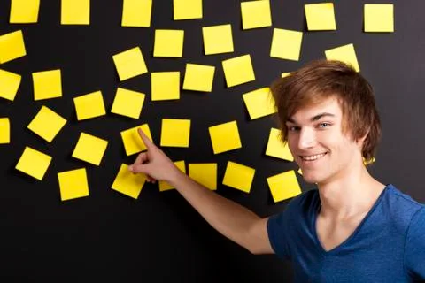 Pointing to a yellow note Stock Photos