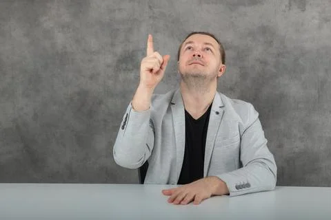 Points up one man in a gray suit Stock Photos