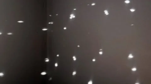 Points of reflected sunlight from glitter ball rushing past on a dark wall Stock Footage 155919628