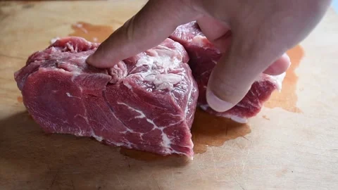 Poke a finger in to frozen beef Stock Footage