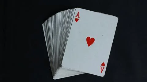 Poker card stack deck on dark black background Stock Photos