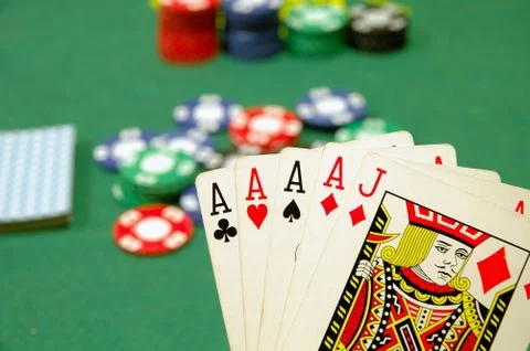 Poker cards four and jack and chips on the poker table Stock Photos