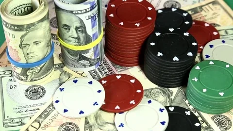 Poker chips and dollars on rotating surface. Stock-Footage 73988893