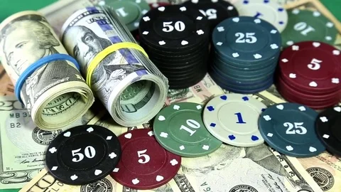 Poker chips and dollars on rotating surface. Stock Footage 73988906