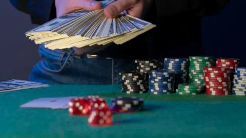 Poker chips and poker dice in the hand Stock Photos