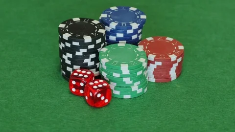 Poker chips and two red dice on table 库存影片 70210531