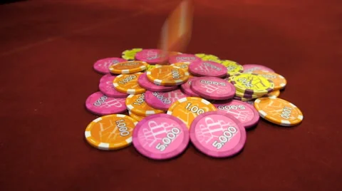 Poker chips fall onto red table Stock Footage 65299650