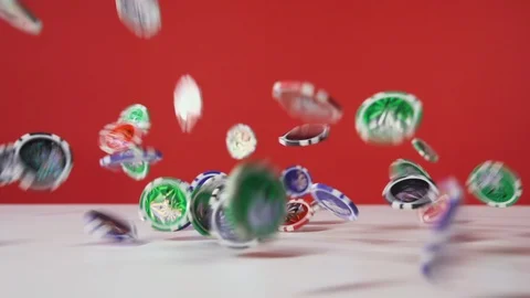 Poker chips falling from ceiling on the table on the red background, 4x rapid Stock Footage 120811303