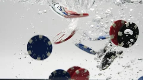 Poker chips falling through the water and slow motion gambling concept isolated  Stock Footage 219442747