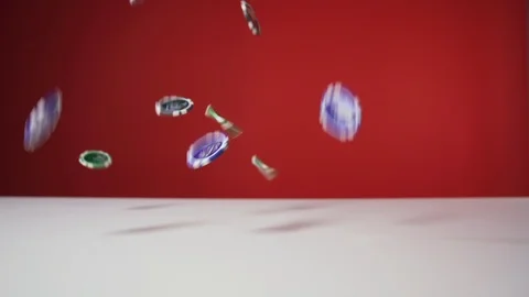 Poker chips falling on the white table on the red background, 4x slow motion Stock Footage 120810077